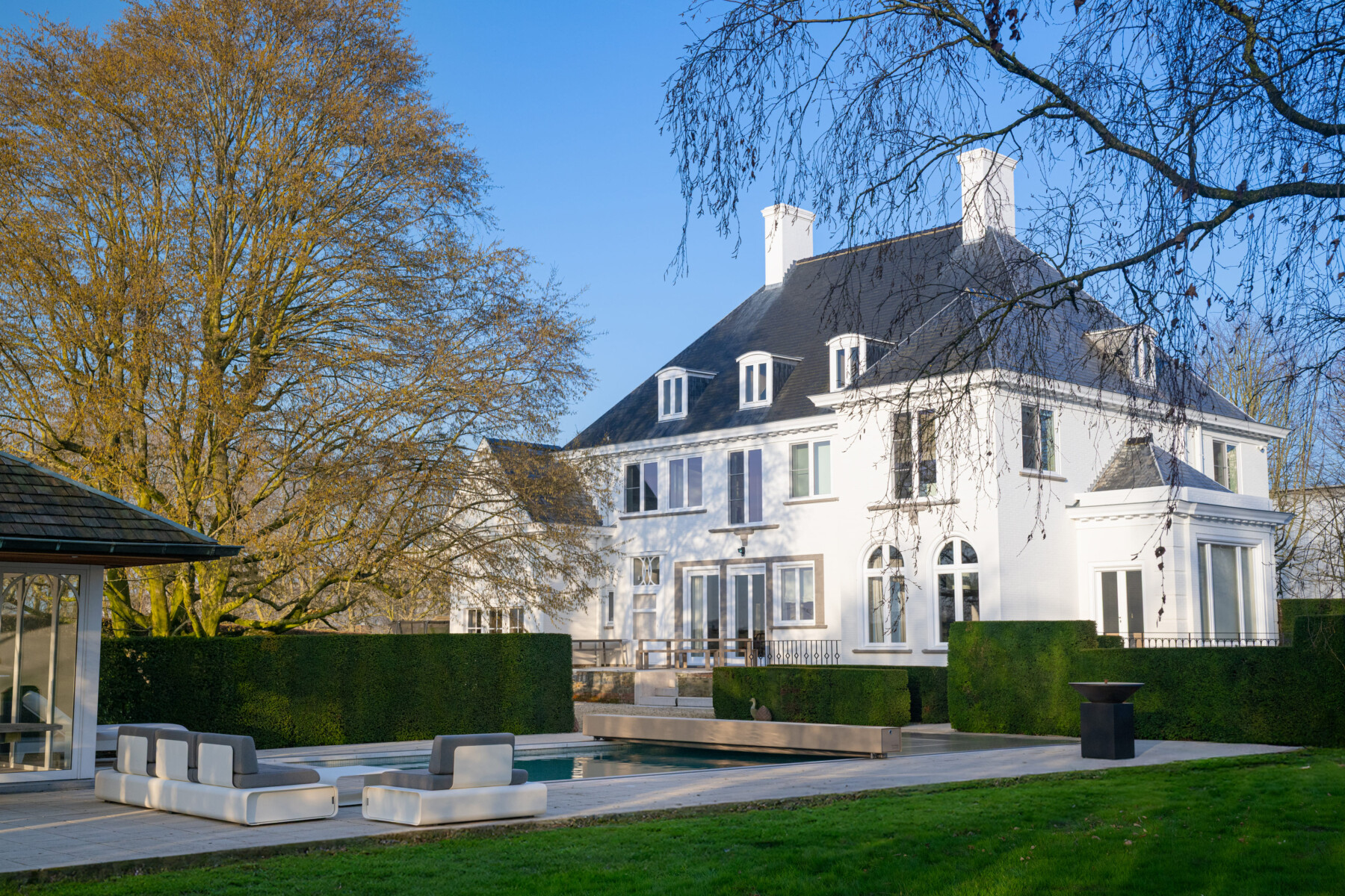 Gros plan sur l’escalier immergé et la couverture Coverseal fermée partiellement, reflétant la lumière sur l’eau turquoise.